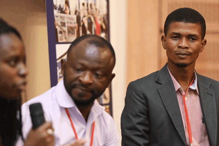 Mongabay Africa staff writer Elodie Toto (left) makes a point during AIJC 2025, alongside staff writer Didier Makal (center) and Mongabay freelance reporter Berdy Pambou (right). Image courtesy of Leon Sadiki/Wits Centre for Journalism.